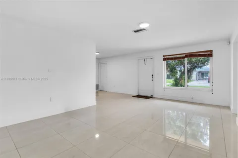 a kitchen with stainless steel appliances granite countertop a stove top oven a sink a dining table and chairs