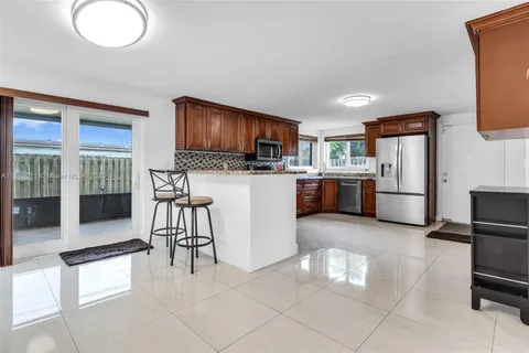a view of a dining room with furniture and a potted plant