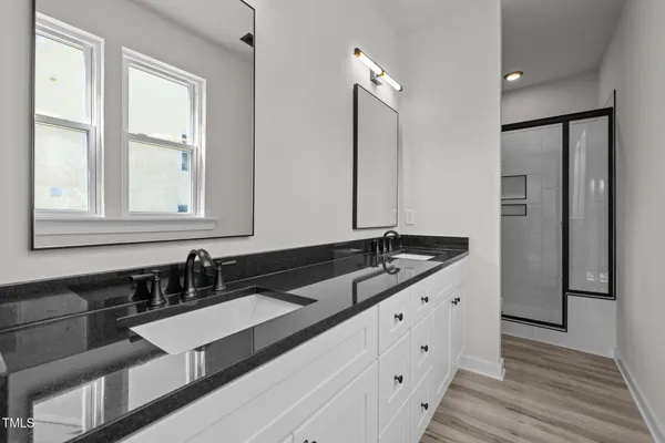 a large bathroom with double vanity and a large mirror