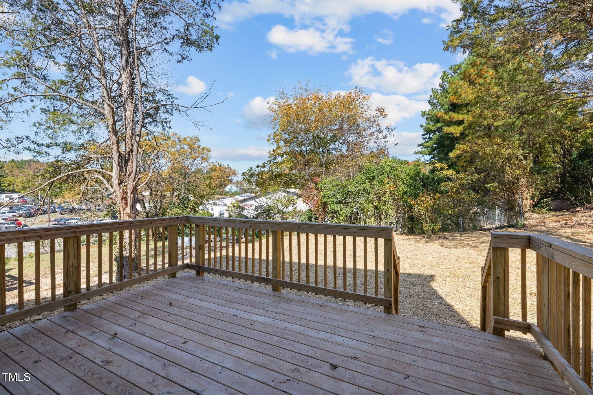 2015 Cheek Road Durham, NC 27704 - Photo 9 of 12 a balcony with wooden floor and fence
