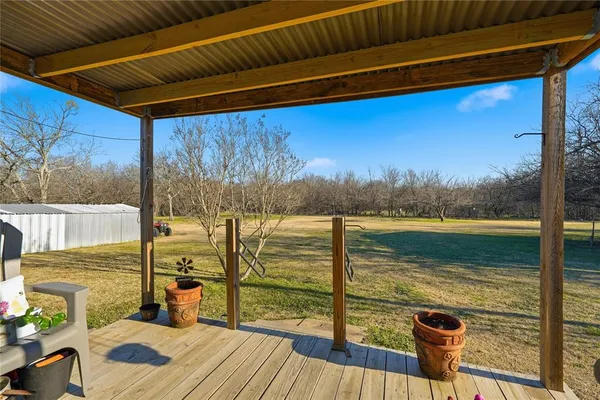 a view of a balcony with lake view and wooden floor