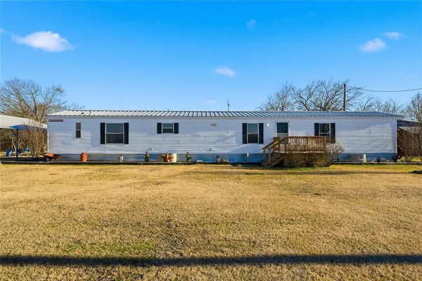 a swimming pool with outdoor seating and yard