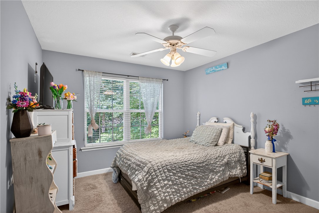 151 Towne Creek Trail Anderson, SC 29621 - Photo 25 of 49 A well-lit bedroom with a ceiling fan, plush carpet, and ample natural light from a large window.