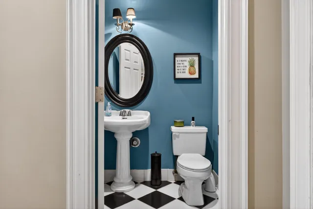 a bathroom with a toilet sink and mirror