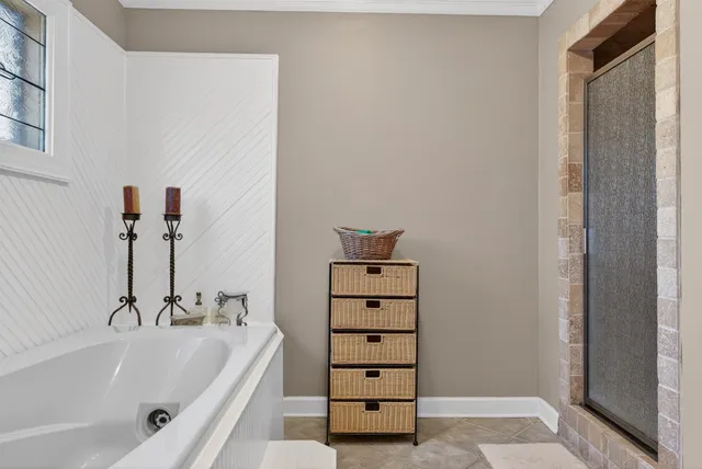 a bathroom with a bathtub and shower