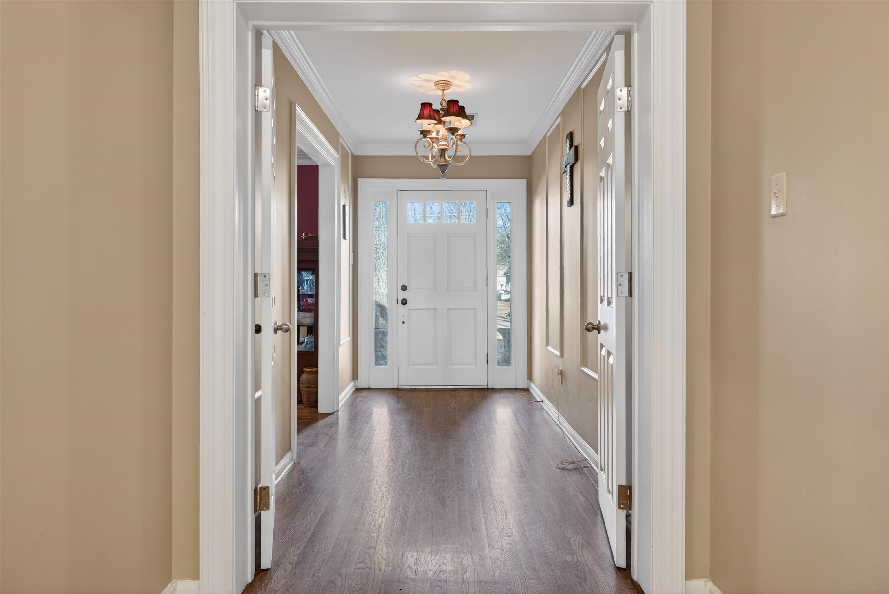 1195 Frank Road Collierville, TN 38017 - Photo 18 of 35 Entrance foyer with dark wood finished floors, a chandelier, and ornamental molding