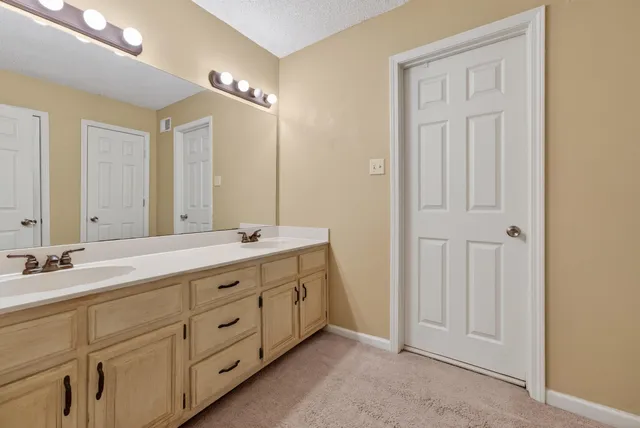 a spacious bathroom with a double vanity sink and a mirror