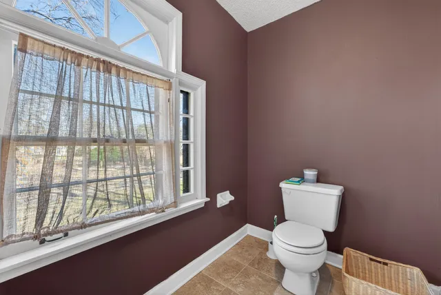 a white toilet sitting next to a window