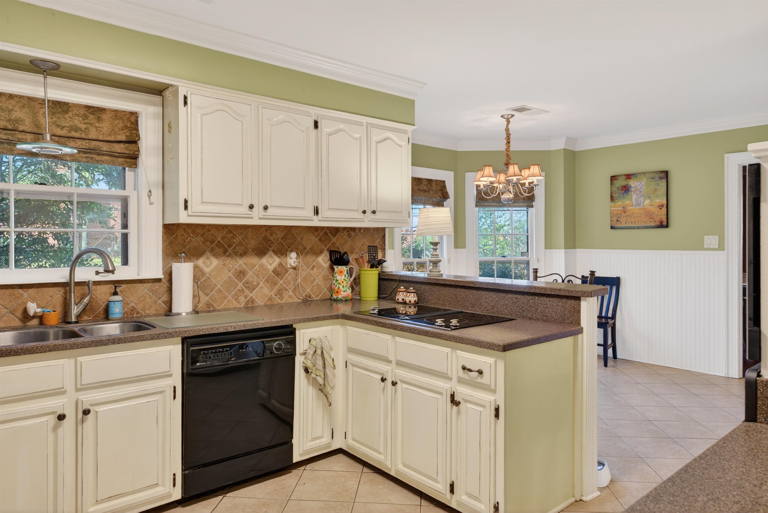 1195 Frank Road Collierville, TN 38017 - Photo 24 of 35 Kitchen featuring decorative light fixtures, black appliances, a peninsula, light tile patterned flooring, and dark countertops