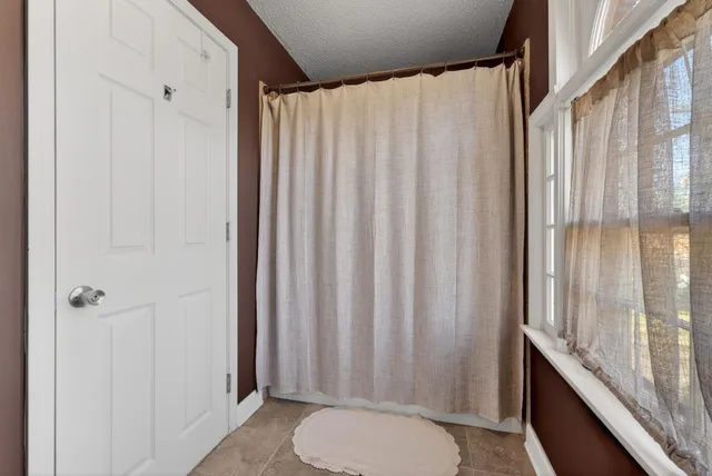 a bathroom with a shower curtain and a sink