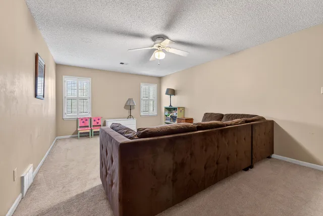 a room with furniture and ceiling fan
