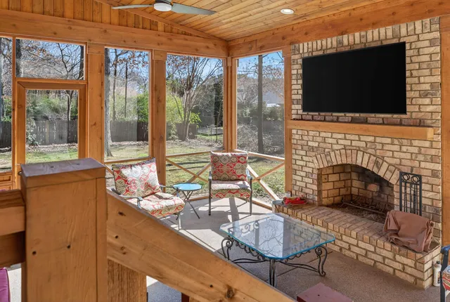 a living room with fireplace furniture and a flat screen tv