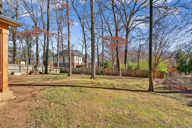 a view of a yard with a tree