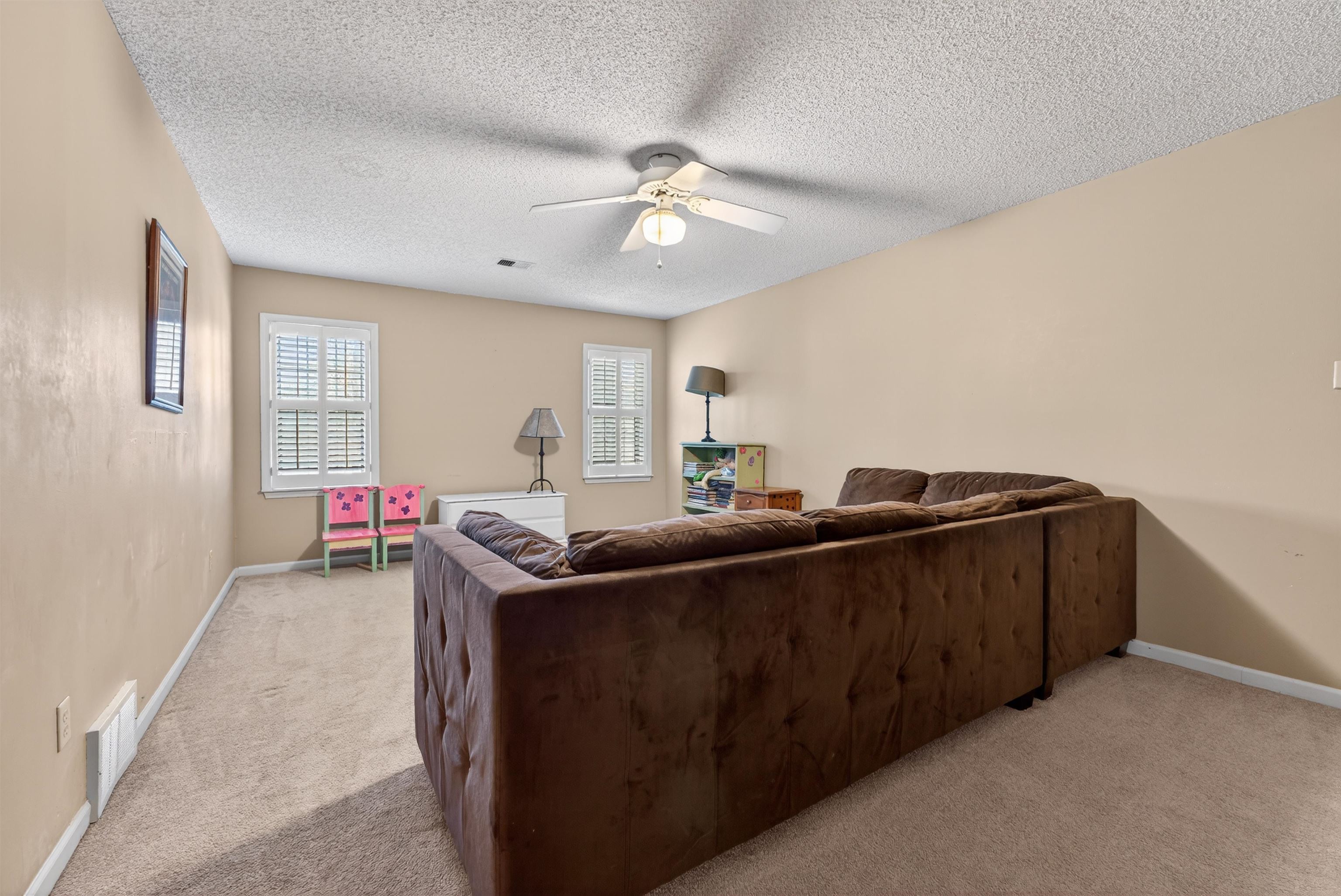 1195 Frank Road Collierville, TN 38017 - Photo 7 of 35 Living area with light colored carpet, ceiling fan, and a textured ceiling