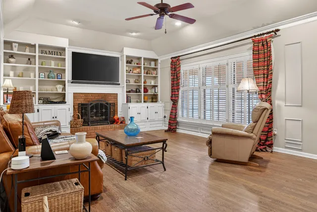 a living room with furniture flat screen tv and a fireplace