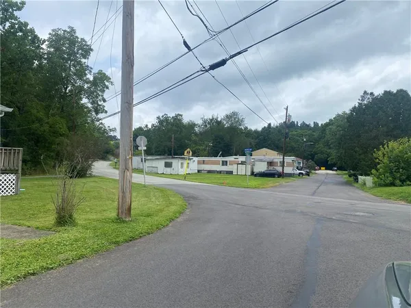 a house with green field in front of it