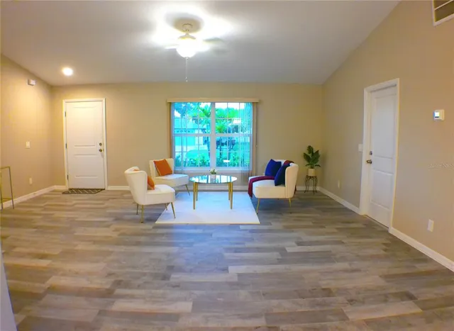 a living room with furniture and a large window
