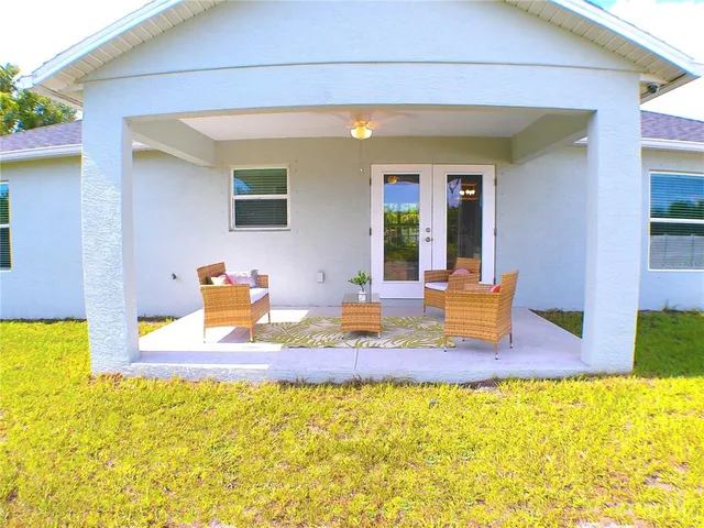 a swimming pool with outdoor seating