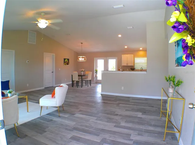 a living room with furniture and a potted plant