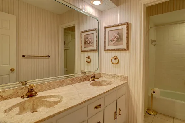 a bathroom with a window and a glass door