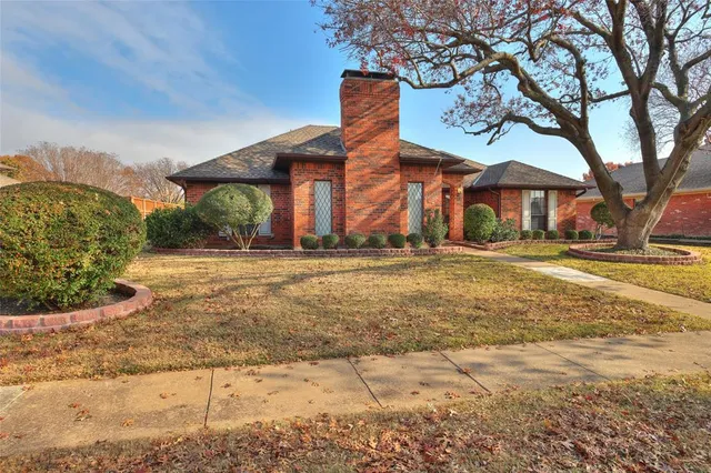 a front view of a building with a yard