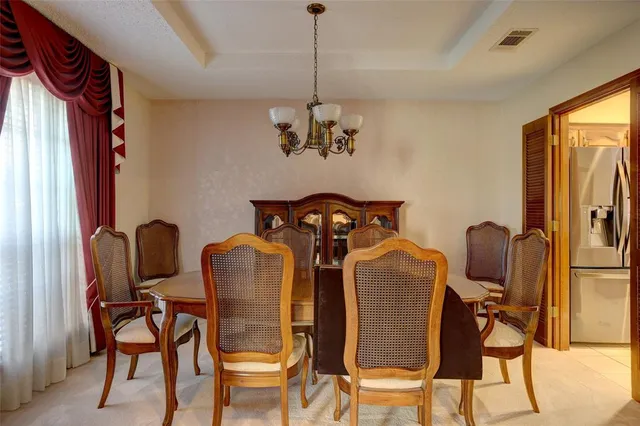 a kitchen with refrigerator and cabinets