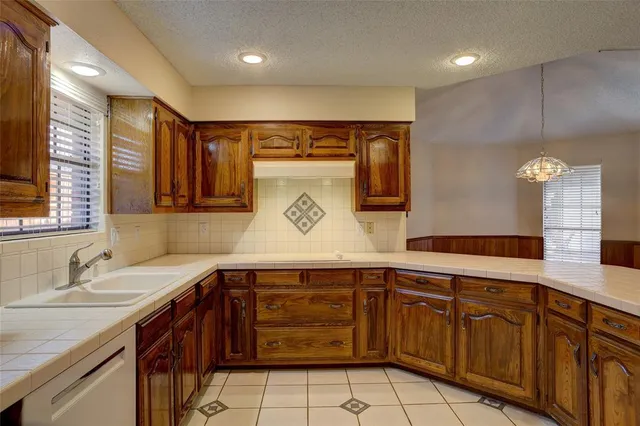 a kitchen with a sink and cabinets