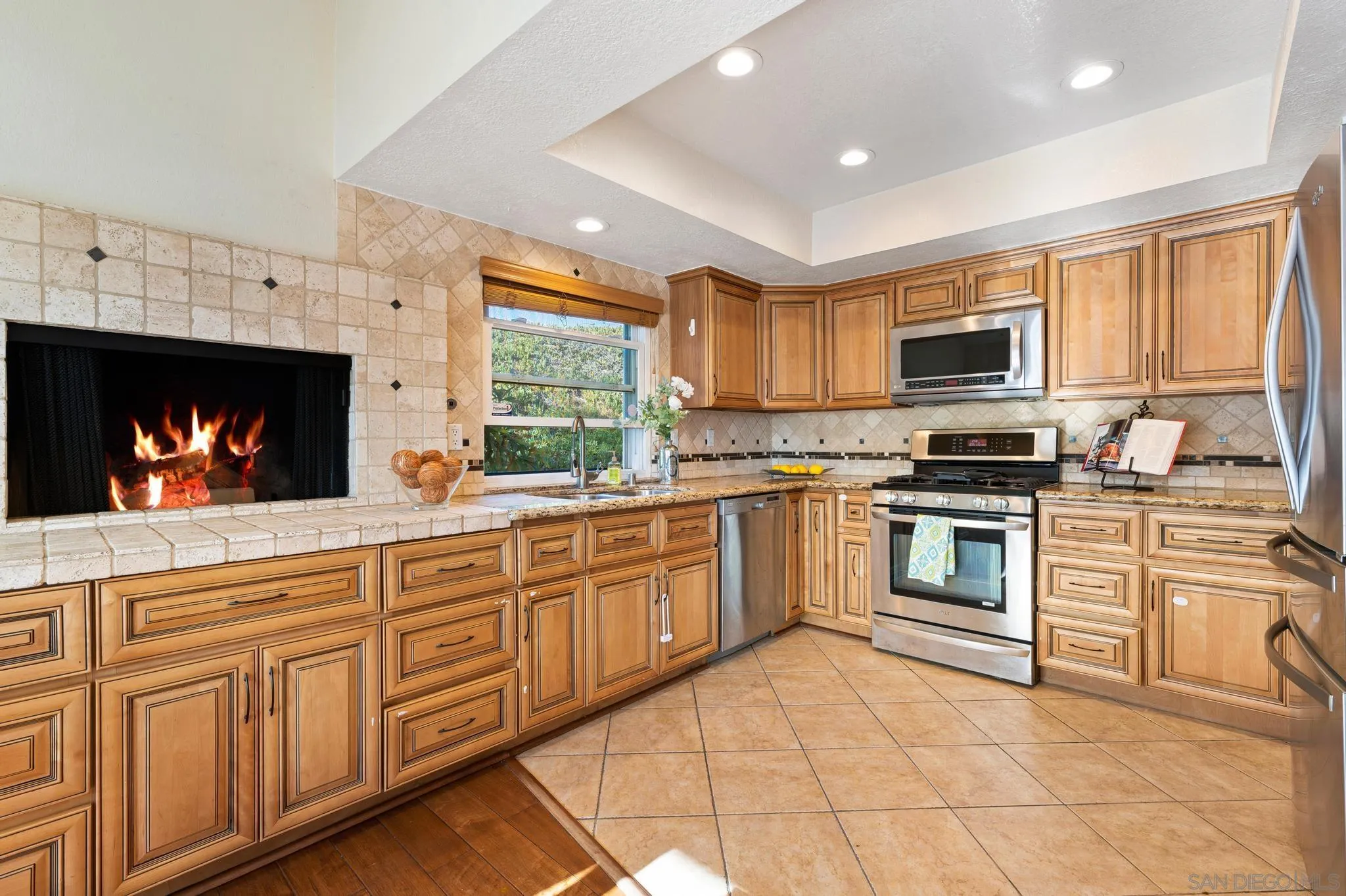 3002 Highlands Way Spring Valley, CA 91977 - Photo 8 of 21 a kitchen with granite countertop a stove top oven sink and cabinets