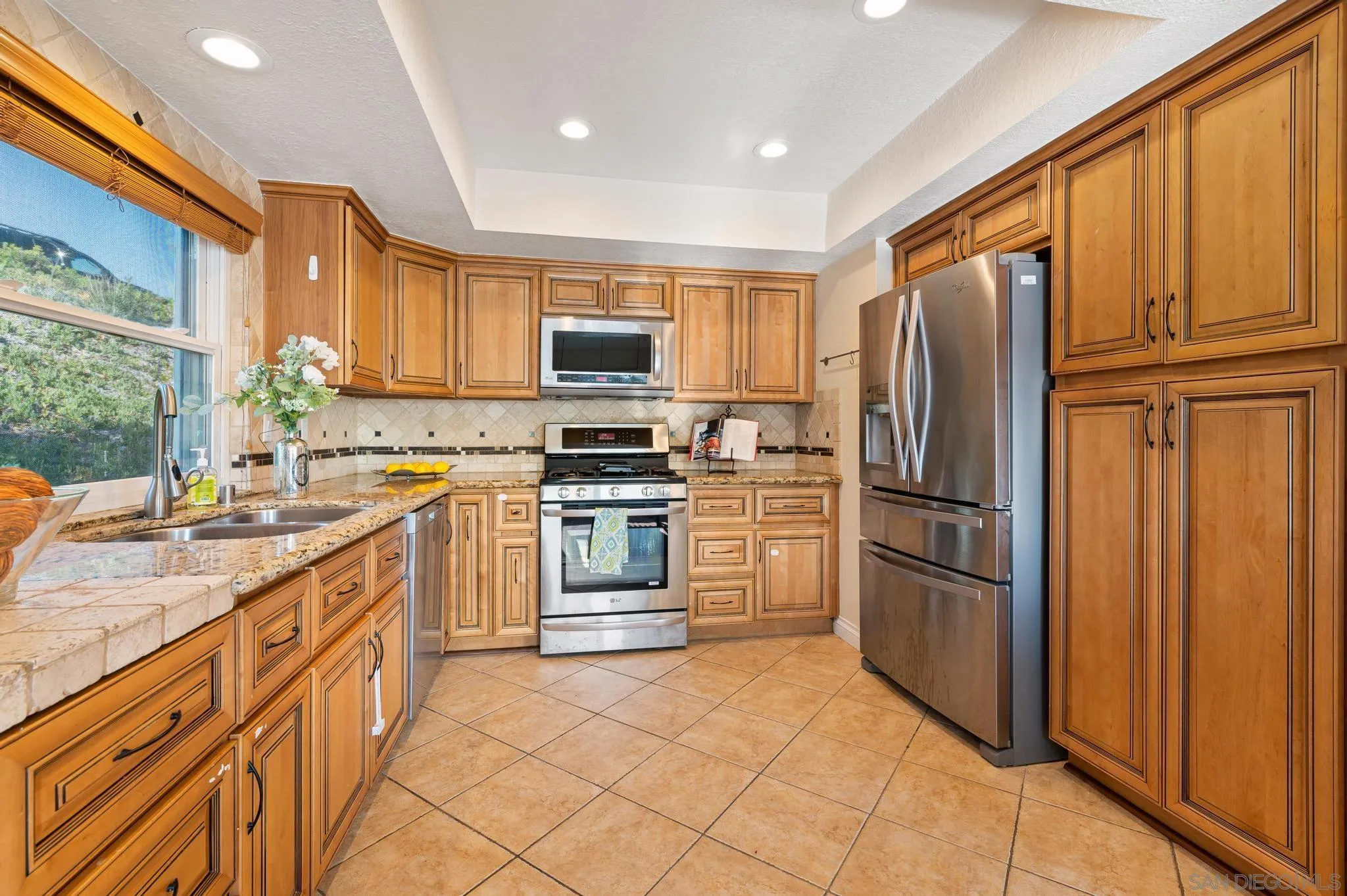 3002 Highlands Way Spring Valley, CA 91977 - Photo 9 of 21 a kitchen with stainless steel appliances granite countertop a refrigerator stove and sink