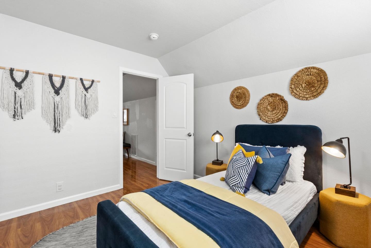 589 Inverness Drive Pacifica, CA 94044 - Photo 11 of 21 a bedroom with a bed and painting on the wall