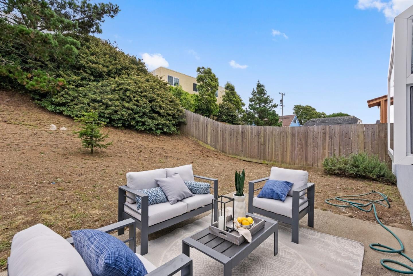 589 Inverness Drive Pacifica, CA 94044 - Photo 17 of 21 a backyard of a house with table and chairs