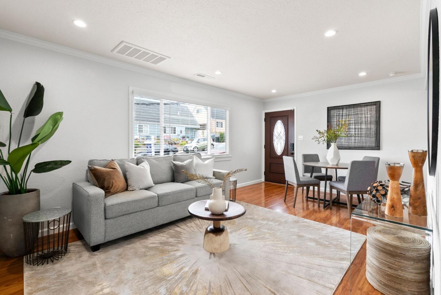 589 Inverness Drive Pacifica, CA 94044 - Photo 4 of 21 a living room with furniture a dining table and a potted plant