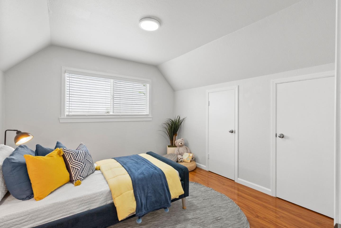 589 Inverness Drive Pacifica, CA 94044 - Photo 10 of 21 a bedroom with a bed and a window