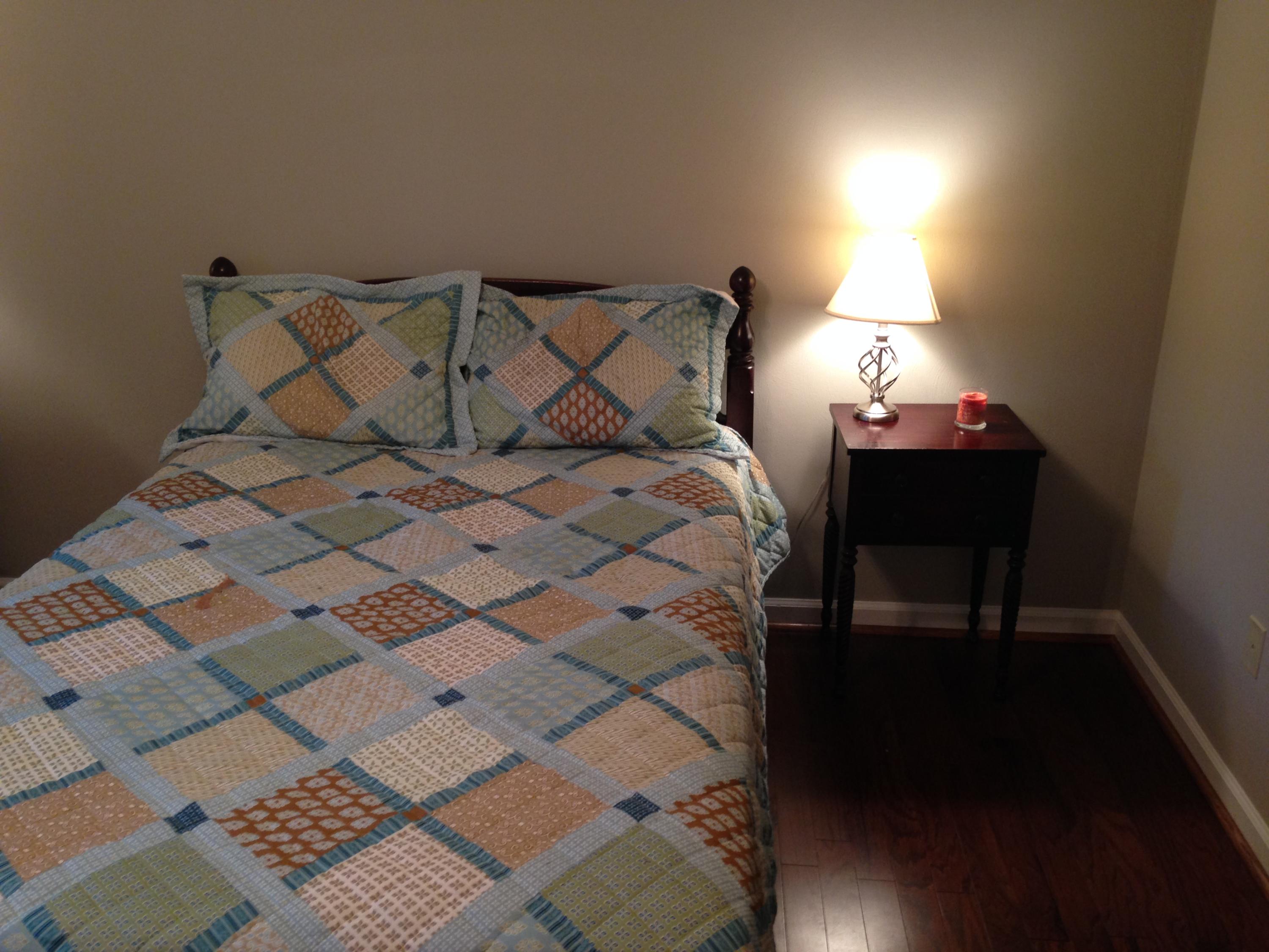 2205 Ridge Road Roanoke, VA 24014 - Photo 19 of 62 a bed sitting in a bedroom next to a lamp with a rug
