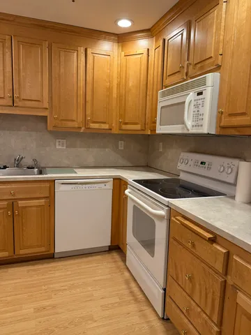 a kitchen with granite countertop cabinets stainless steel appliances and sink