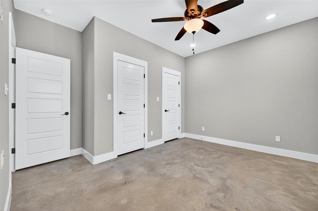 1431 South 7th Avenue Denison, TX 75021 - Photo 12 of 21 an empty room with chandelier fan