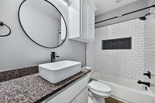 a bathroom with a sink a toilet and a mirror