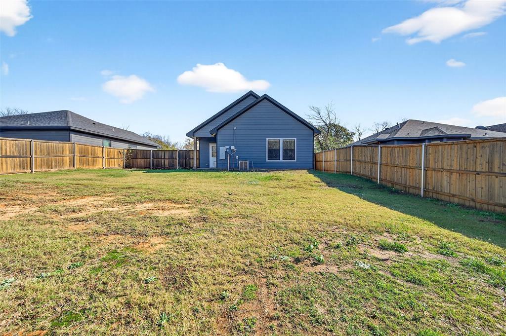 1431 South 7th Avenue Denison, TX 75021 - Photo 20 of 21 a view of a house with a yard and a large tree