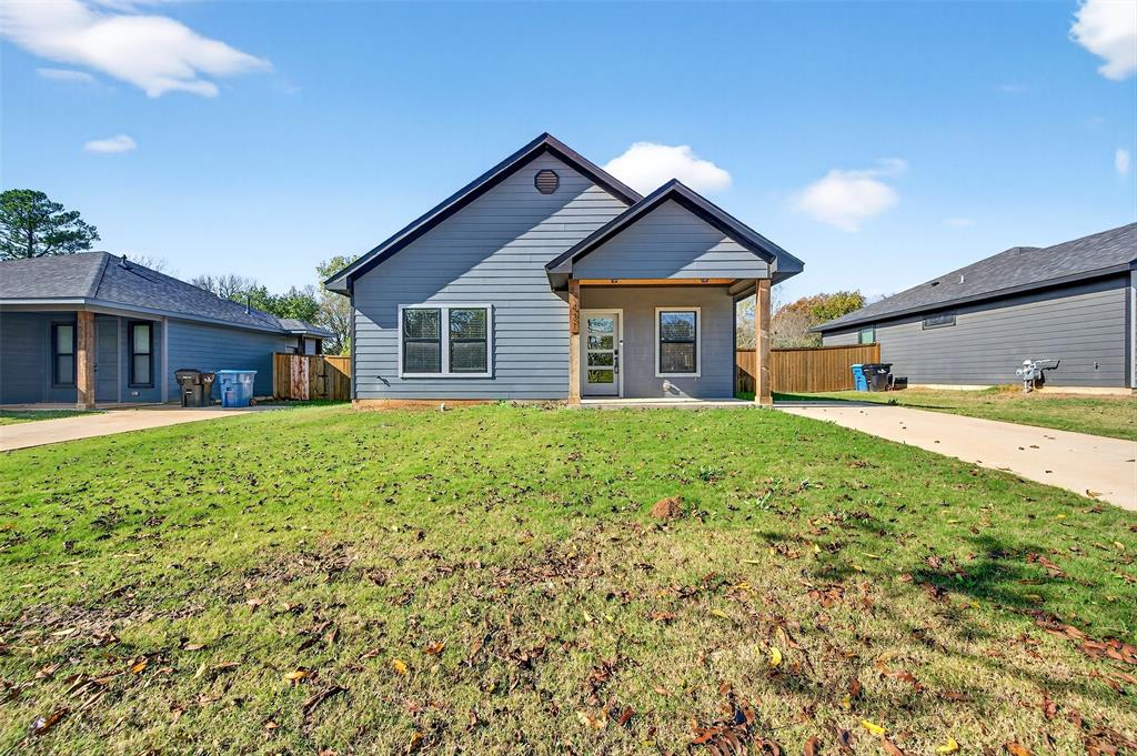 1431 South 7th Avenue Denison, TX 75021 - Photo 3 of 21 a front view of a house with a yard