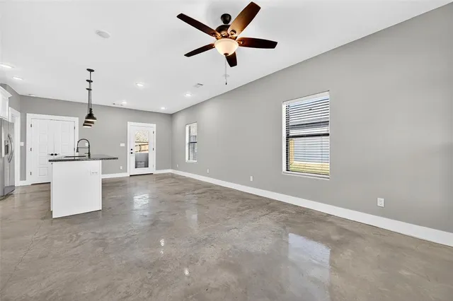 a view of an empty room with a kitchen