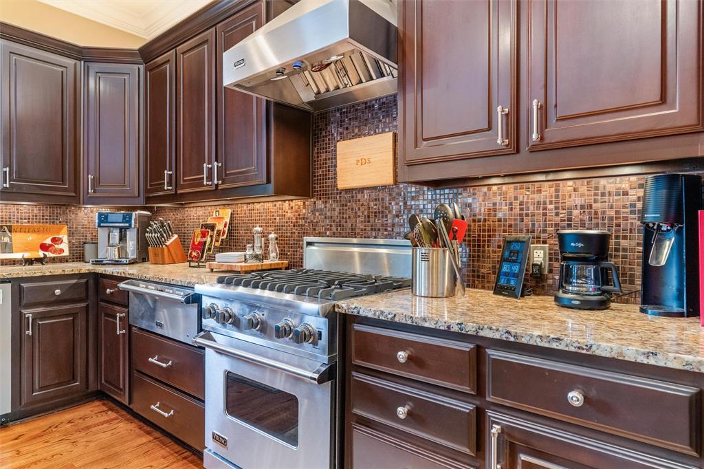 4931 Milam Street Dallas, TX 75206 - Photo 11 of 30 a kitchen with granite countertop stainless steel appliances and wooden cabinets