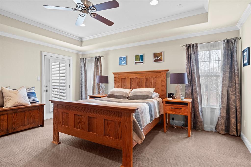 4931 Milam Street Dallas, TX 75206 - Photo 15 of 30 a bedroom with a bed and a chandelier