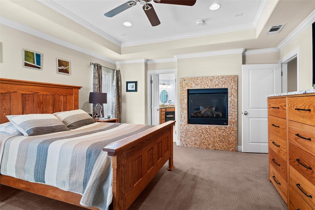 4931 Milam Street Dallas, TX 75206 - Photo 16 of 30 a bed room with a bed and a fireplace