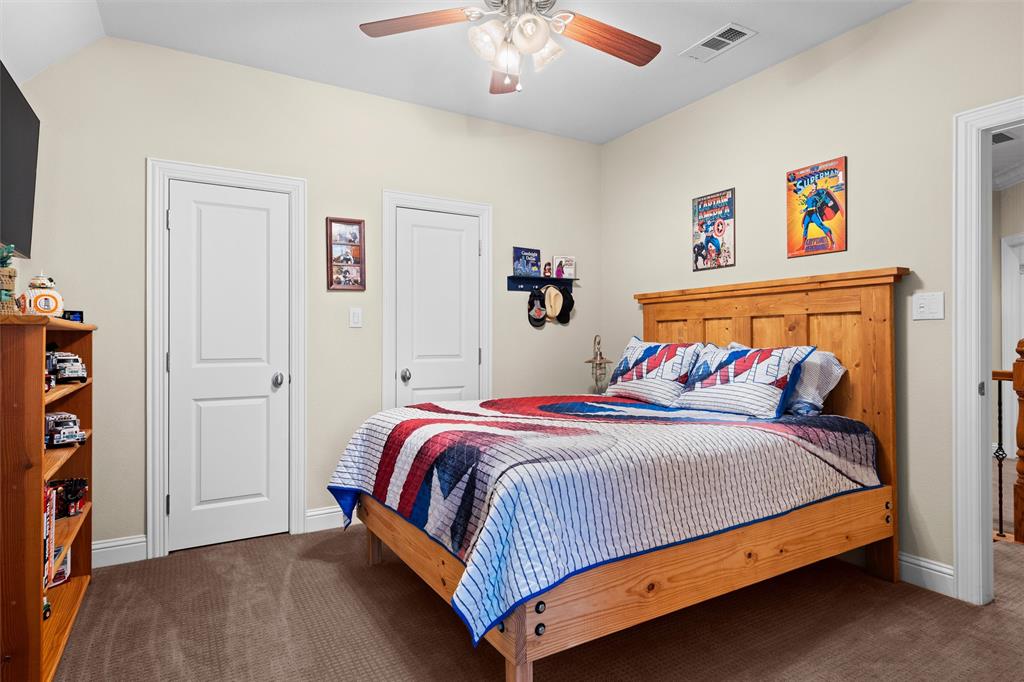 4931 Milam Street Dallas, TX 75206 - Photo 21 of 30 a bedroom with a bed and book shelf