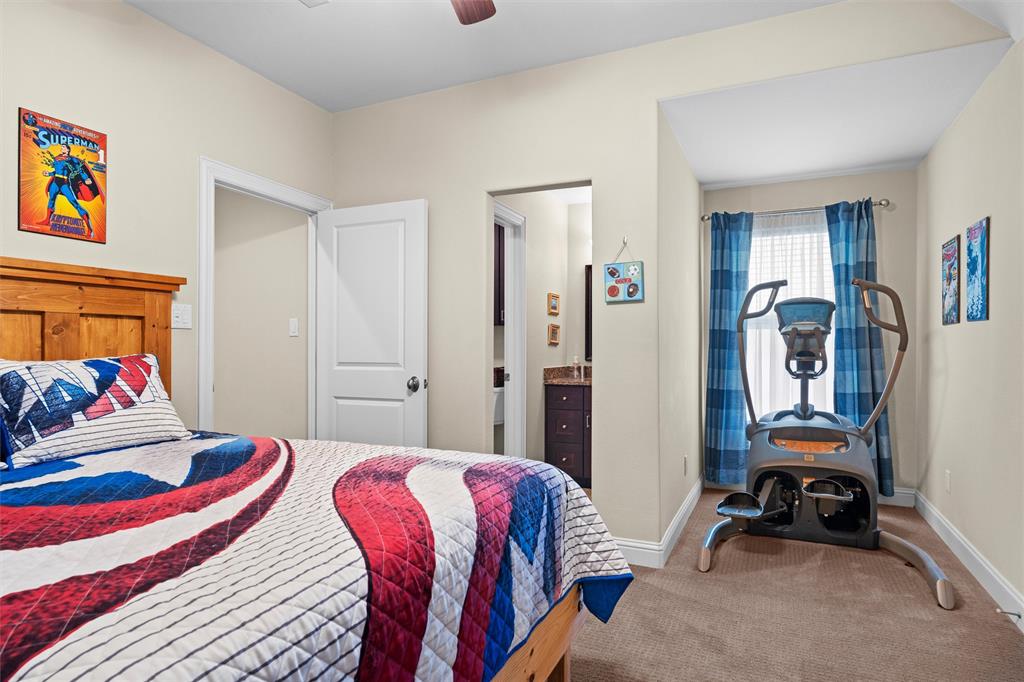 4931 Milam Street Dallas, TX 75206 - Photo 22 of 30 a bedroom with a bed a standing and a bookshelf