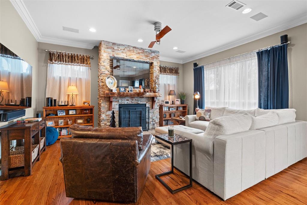 4931 Milam Street Dallas, TX 75206 - Photo 7 of 30 a living room with furniture a fireplace and a flat screen tv