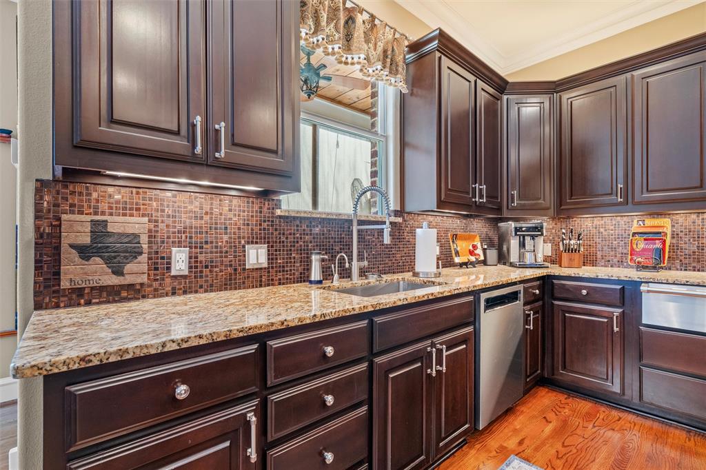 4931 Milam Street Dallas, TX 75206 - Photo 10 of 30 a kitchen with stainless steel appliances granite countertop a sink stove and cabinets