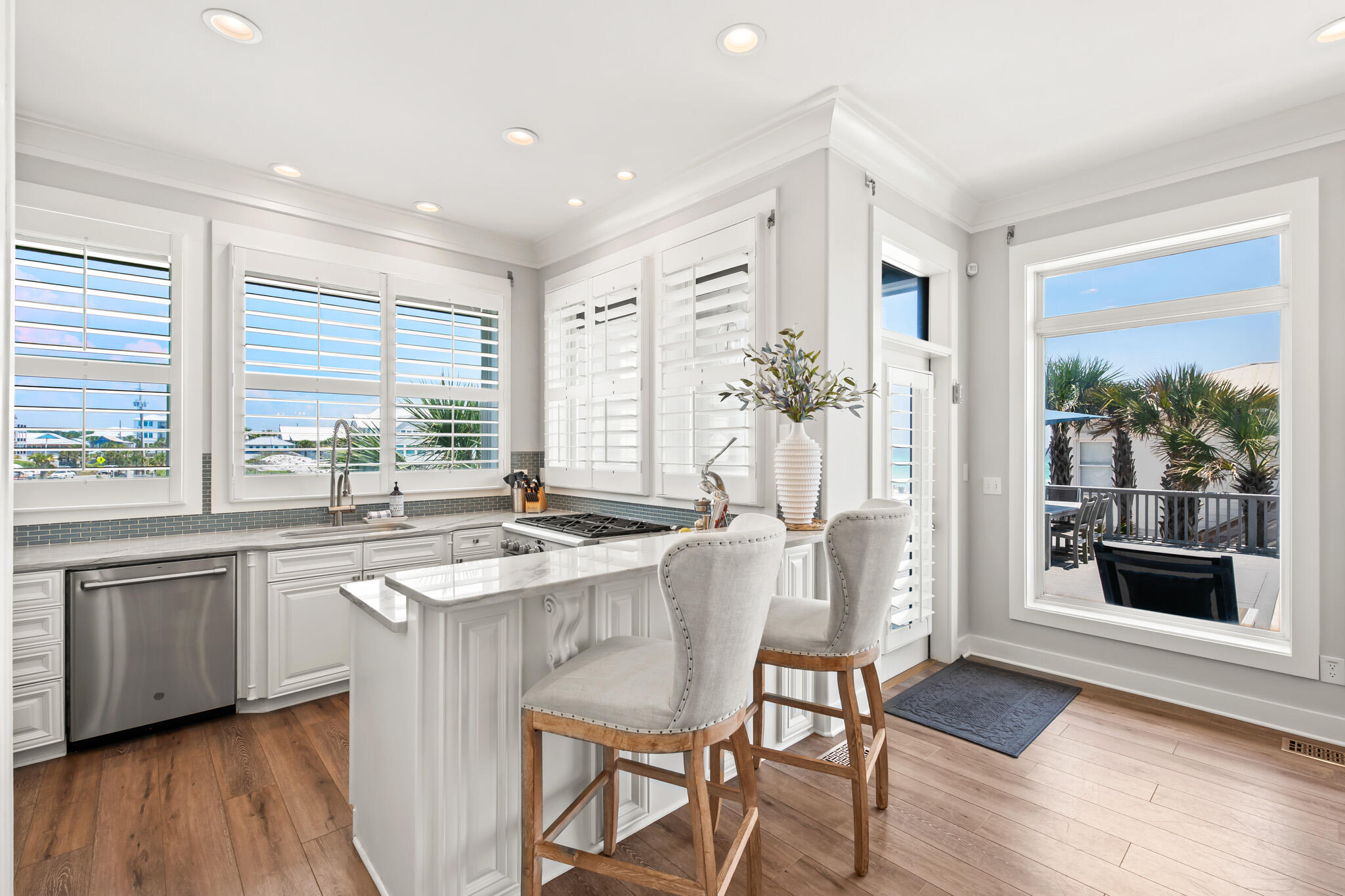 15 Fort Panic Road Santa Rosa Beach, FL 32459 - Photo 40 of 84 a kitchen with stainless steel appliances granite countertop a stove a refrigerator a kitchen island with a stove and white cabinets