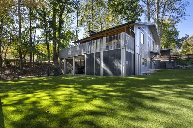 a backyard of a house with table and chairs