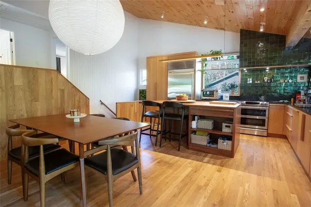 a bedroom with a bed a chandelier and a window